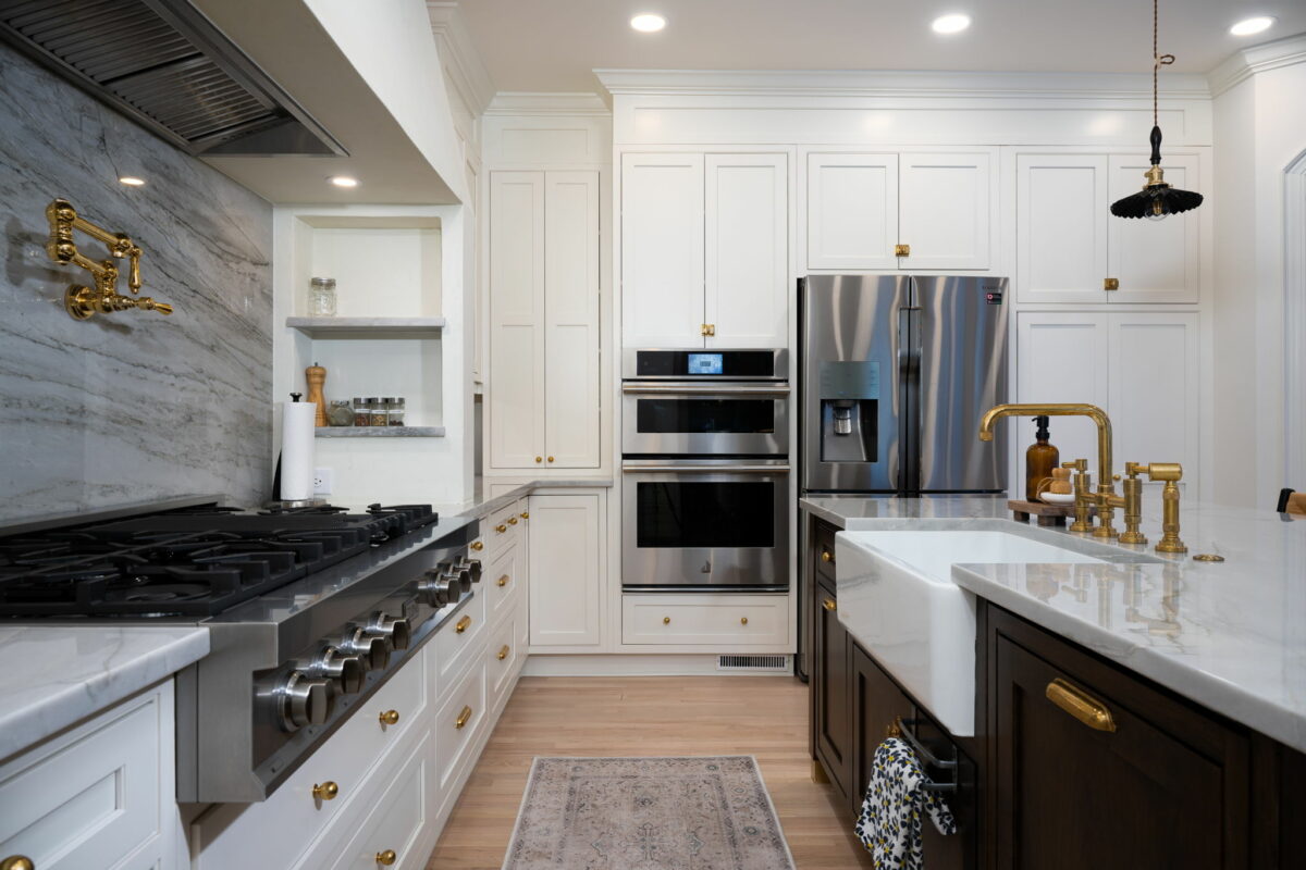 An award-winning kitchen remodel in Charlotte with white cabinets and gold accents.